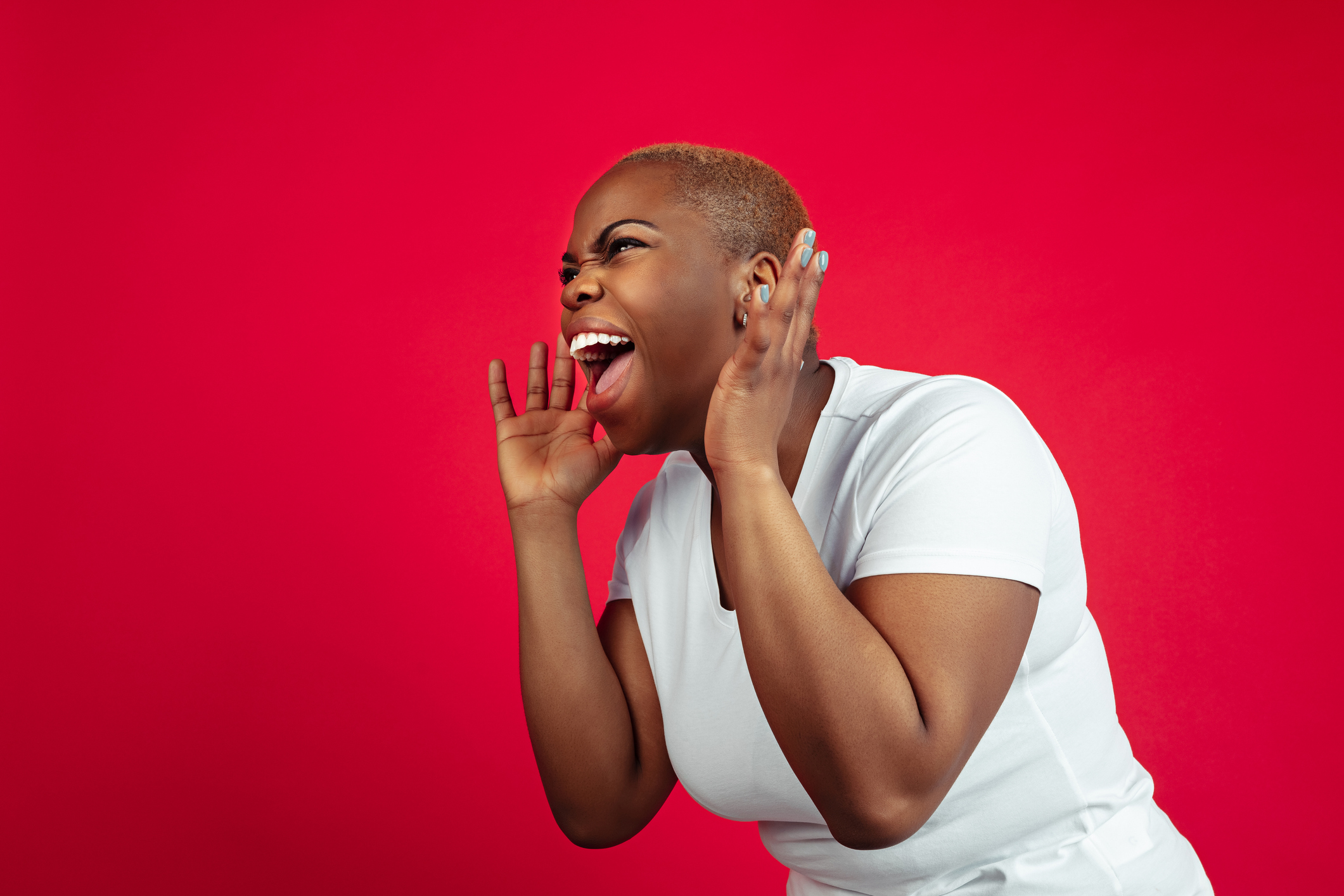 African-american young woman's portrait on red background